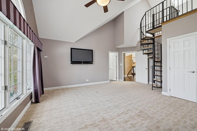 22 Westlake Dr, South Barrington, IL 60010 - unfurnished living room with high vaulted ceiling, plenty of natural light, ceiling fan, stairs, and carpet floors
