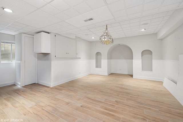 22 Westlake Dr, South Barrington, IL 60010 - spare room featuring wainscoting, light wood-style floors, and a chandelier