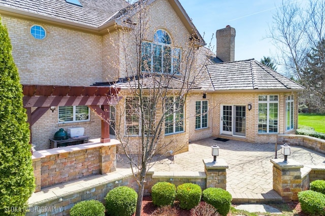 22 Westlake Dr, South Barrington, IL 60010 - rear view of property with brick siding, a chimney, a patio area, and a pergola