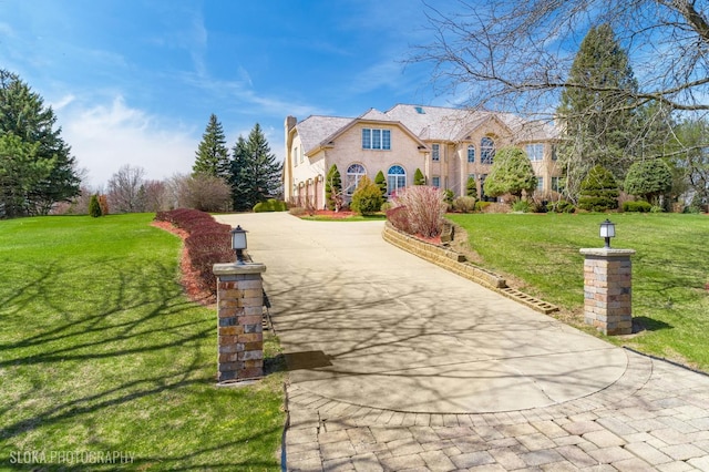 22 Westlake Dr, South Barrington, IL 60010 - view of front facade with concrete driveway, a front lawn, and a chimney