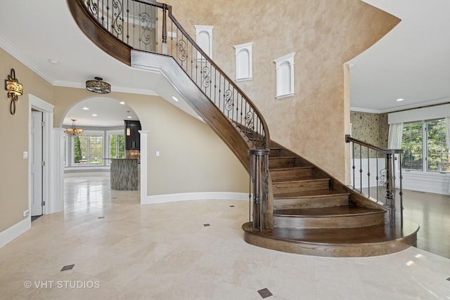 22 Westlake Dr, South Barrington, IL 60010 - stairway featuring ornamental molding, a chandelier, arched walkways, a towering ceiling, and recessed lighting