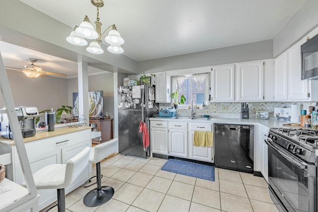 10354 Parkside Ave Unit 3A, Oak Lawn, IL 60453 - kitchen with black appliances, a chandelier, white cabinetry, light countertops, and decorative light fixtures