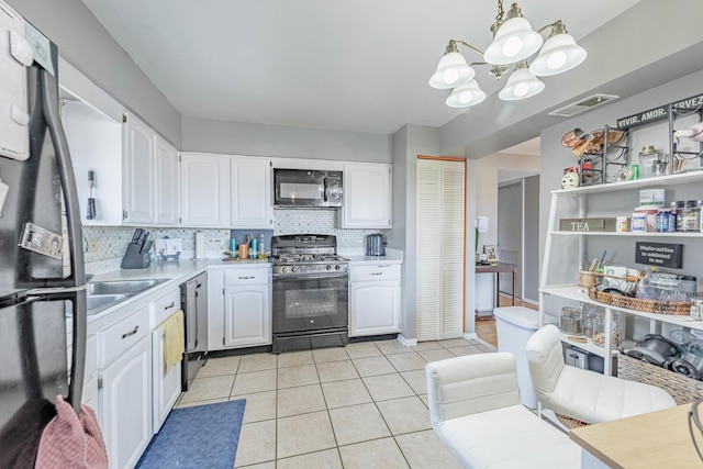 10354 Parkside Ave Unit 3A, Oak Lawn, IL 60453 - kitchen with black appliances, a chandelier, white cabinets, and decorative backsplash
