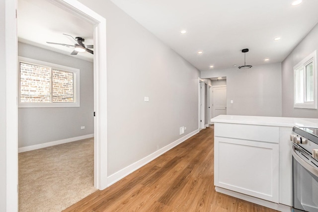 527 N Saint Louis Ave, Chicago, IL 60624 - kitchen with a ceiling fan, white cabinetry, light wood-style floors, recessed lighting, and light countertops