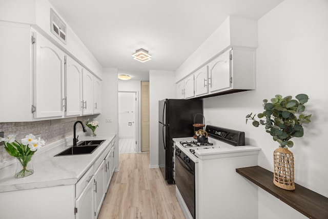 1475 Rebecca Dr Unit 311, Hoffman Estates, IL 60169 - kitchen with white gas range, light wood-style floors, white cabinetry, light countertops, and decorative backsplash