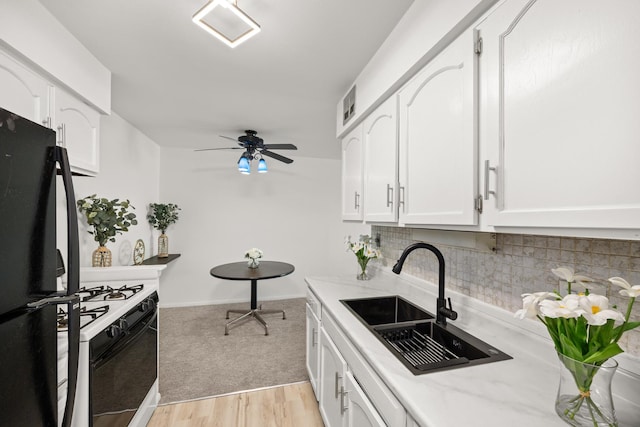 1475 Rebecca Dr Unit 311, Hoffman Estates, IL 60169 - kitchen featuring freestanding refrigerator, gas range oven, and white cabinets