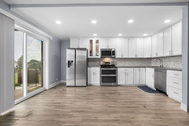 850 Des Plaines Ave Unit 405, Forest Park, IL 60130 - kitchen featuring appliances with stainless steel finishes, tasteful backsplash, recessed lighting, white cabinetry, and glass insert cabinets