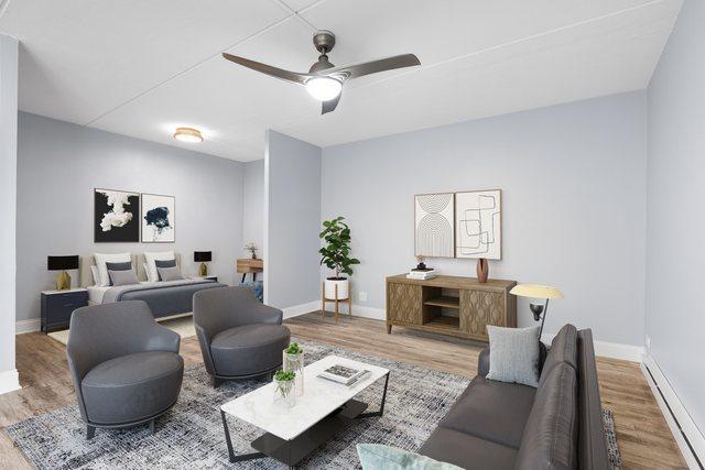 850 Des Plaines Ave Unit 405, Forest Park, IL 60130 - living room featuring baseboard heating, wood finished floors, and ceiling fan