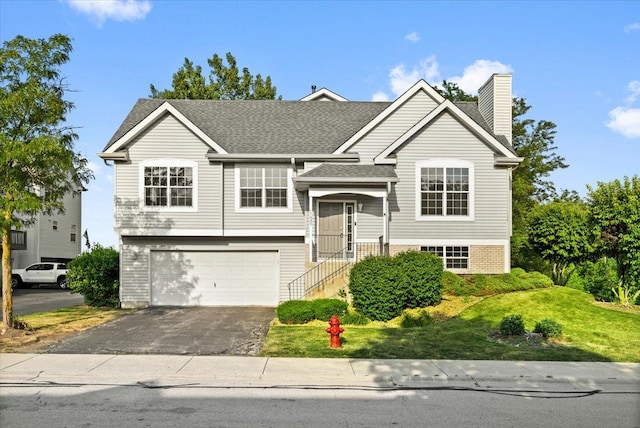 17437 Yakima Dr, Lockport, IL 60441 - bi-level home with a garage, driveway, a chimney, a front yard, and a shingled roof