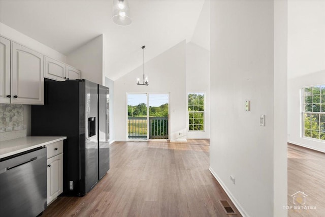 17437 Yakima Dr, Lockport, IL 60441 - kitchen featuring appliances with stainless steel finishes, high vaulted ceiling, light wood-type flooring, light countertops, and hanging light fixtures