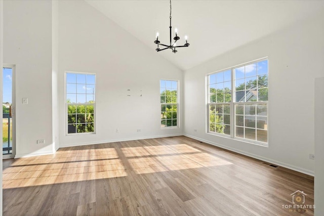 17437 Yakima Dr, Lockport, IL 60441 - unfurnished dining area featuring high vaulted ceiling, a chandelier, wood finished floors, and plenty of natural light