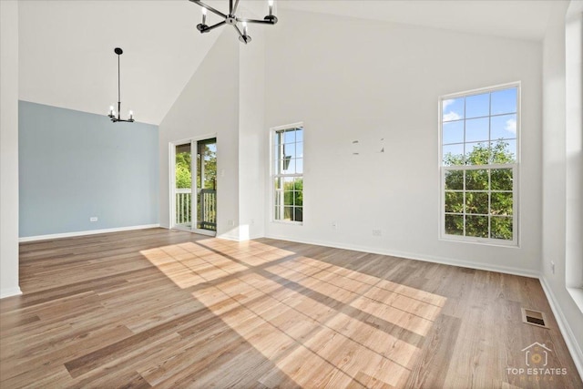 17437 Yakima Dr, Lockport, IL 60441 - spare room featuring a chandelier, high vaulted ceiling, and wood finished floors