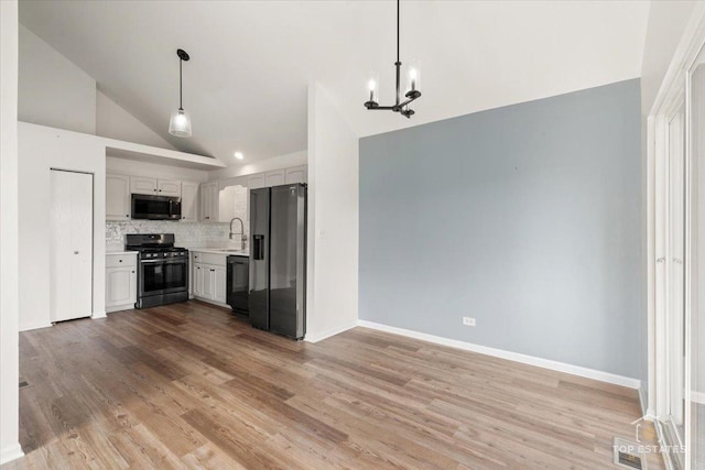 17437 Yakima Dr, Lockport, IL 60441 - kitchen with range with gas cooktop, stainless steel refrigerator with ice dispenser, high vaulted ceiling, dishwasher, and light countertops