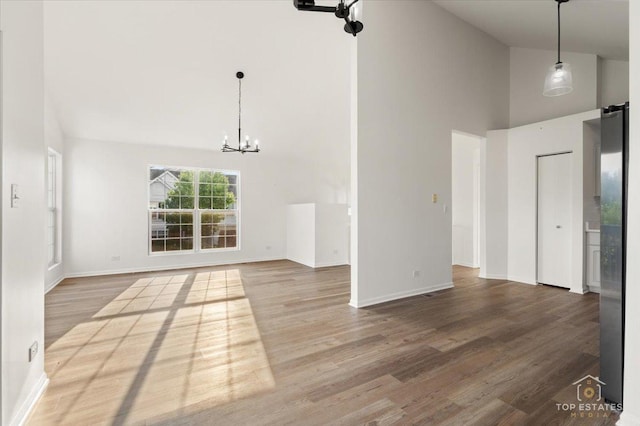 17437 Yakima Dr, Lockport, IL 60441 - unfurnished living room featuring high vaulted ceiling, a chandelier, and wood finished floors