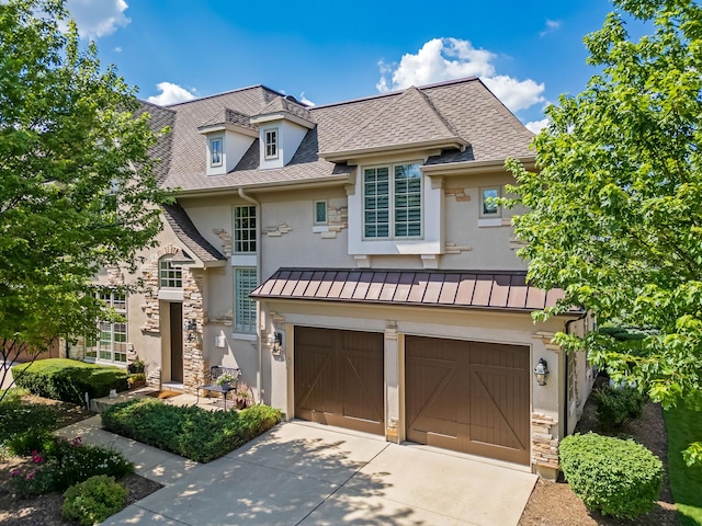 8 Willowcrest Dr, Oak Brook, IL 60523 - view of front of home featuring stucco siding, a standing seam roof, stone siding, concrete driveway, and an attached garage