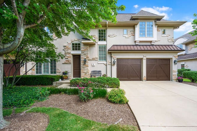 8 Willowcrest Dr, Oak Brook, IL 60523 - view of front of home featuring concrete driveway, a garage, a standing seam roof, stucco siding, and stone siding