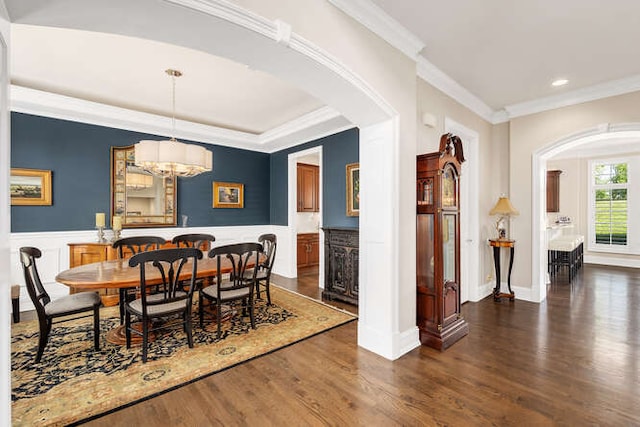 8 Willowcrest Dr, Oak Brook, IL 60523 - dining space with arched walkways, ornamental molding, dark wood-style floors, wainscoting, and recessed lighting