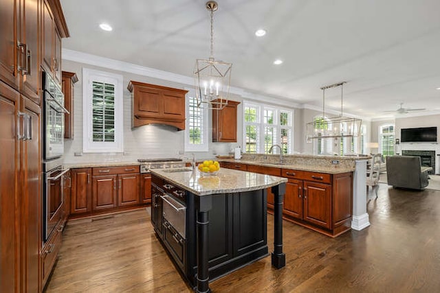 8 Willowcrest Dr, Oak Brook, IL 60523 - kitchen with open floor plan, ornamental molding, dark wood-type flooring, tasteful backsplash, and a kitchen breakfast bar