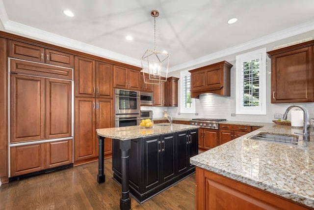 8 Willowcrest Dr, Oak Brook, IL 60523 - kitchen featuring stainless steel appliances, crown molding, light stone counters, decorative light fixtures, and an island with sink