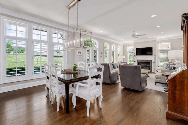 8 Willowcrest Dr, Oak Brook, IL 60523 - dining space with a ceiling fan, dark wood finished floors, crown molding, a glass covered fireplace, and recessed lighting