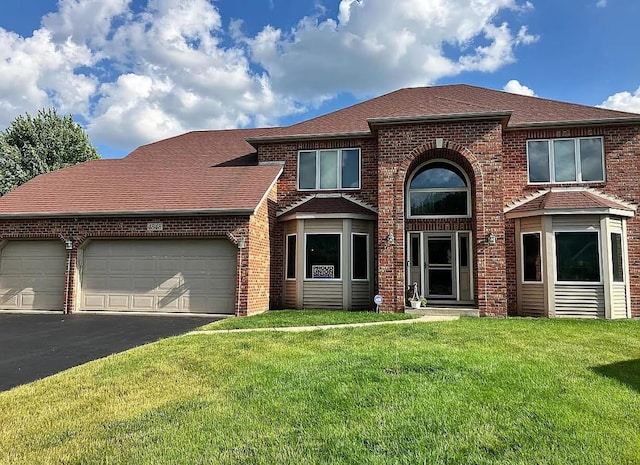 4848 Snapjack Cir, Naperville, IL 60564 - traditional home with brick siding, an attached garage, asphalt driveway, and a front yard