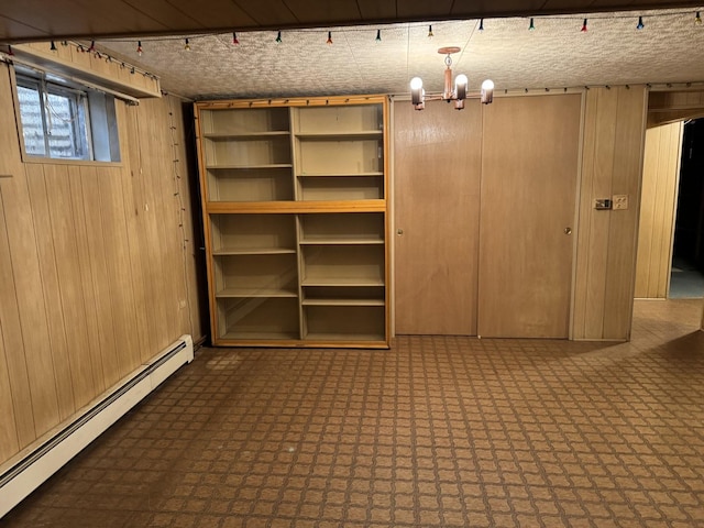 1S513 Chase Ave, Lombard, IL 60148 - basement with a baseboard radiator, wood walls, tile patterned floors, and a chandelier