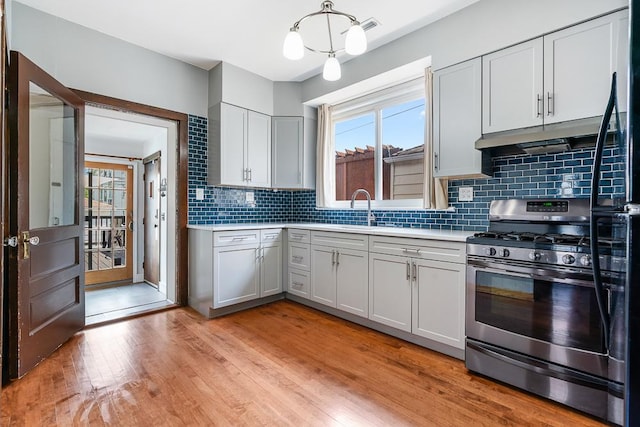 5240 W Eddy St, Chicago, IL 60641 - kitchen featuring gas range, light countertops, healthy amount of natural light, and light wood-style flooring