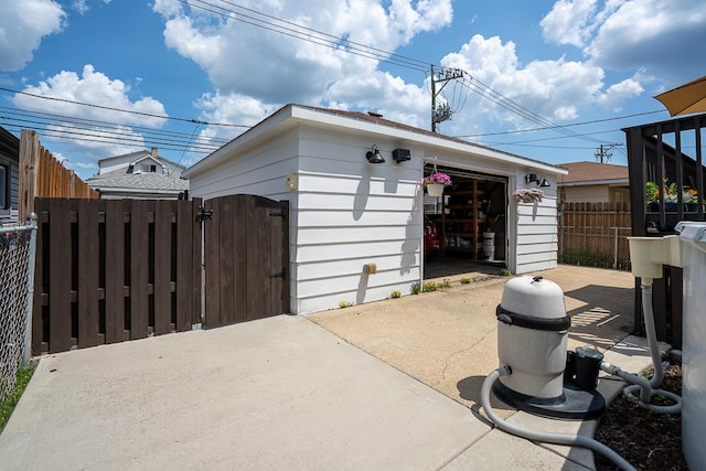 5240 W Eddy St, Chicago, IL 60641 - view of property exterior with a gate, an outdoor structure, and a detached garage