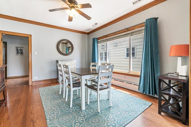 5240 W Eddy St, Chicago, IL 60641 - dining room featuring crown molding, a ceiling fan, and wood finished floors