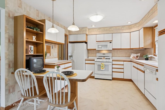 513 James Ct, Algonquin, IL 60102 - kitchen with white appliances, light countertops, white cabinetry, and decorative light fixtures