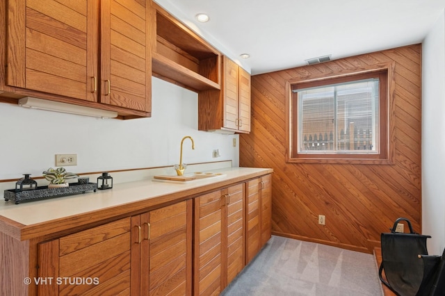 513 James Ct, Algonquin, IL 60102 - kitchen featuring wood walls, light countertops, brown cabinets, open shelves, and light colored carpet