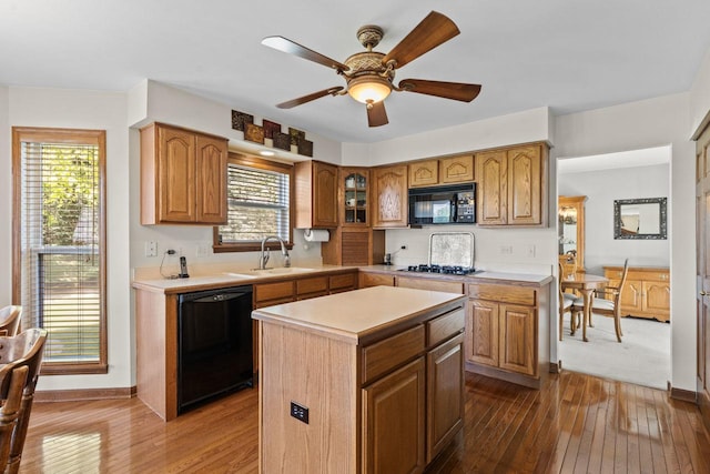 1450 Anvil Ct, Bartlett, IL 60103 - kitchen with black appliances, wood-type flooring, light countertops, and a kitchen island