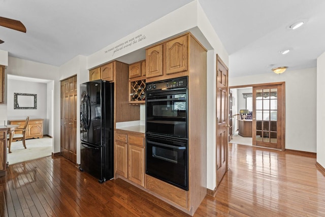 1450 Anvil Ct, Bartlett, IL 60103 - kitchen with black appliances, dark wood-type flooring, brown cabinetry, and light countertops