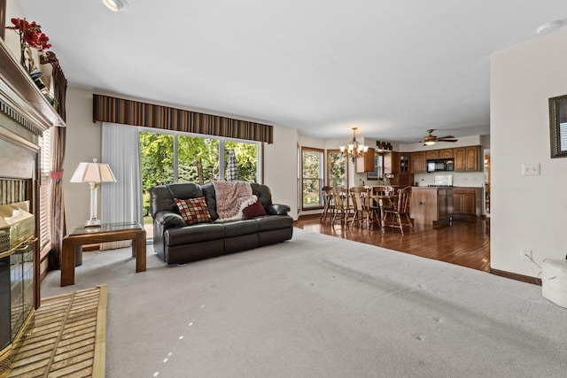 1450 Anvil Ct, Bartlett, IL 60103 - living room with a chandelier, dark carpet, a ceiling fan, and dark wood finished floors