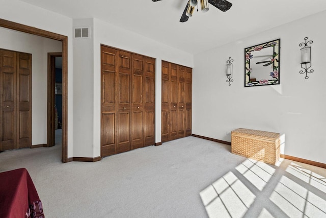 1450 Anvil Ct, Bartlett, IL 60103 - unfurnished bedroom featuring two closets, carpet floors, and ceiling fan