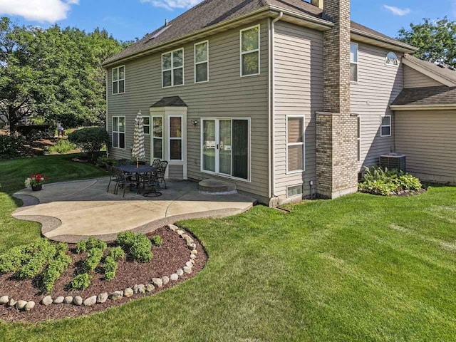 1450 Anvil Ct, Bartlett, IL 60103 - rear view of property featuring a chimney, a patio, a lawn, and roof with shingles