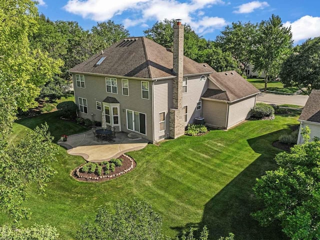 1450 Anvil Ct, Bartlett, IL 60103 - rear view of house with a patio, a chimney, and a lawn