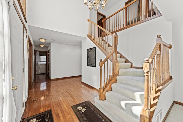 1450 Anvil Ct, Bartlett, IL 60103 - foyer entrance with hardwood / wood-style floors, stairs, a chandelier, and a high ceiling