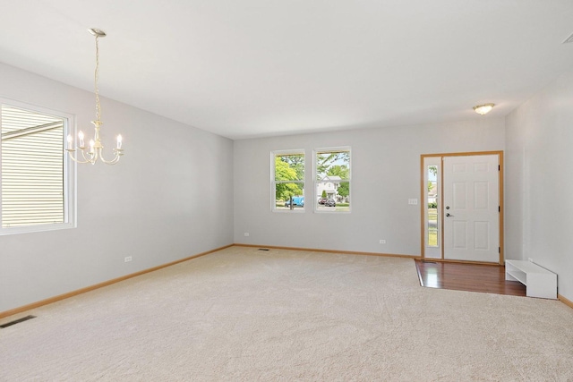 691 Glen Cove Ln, Pingree Grove, IL 60140 - empty room featuring carpet floors and a chandelier