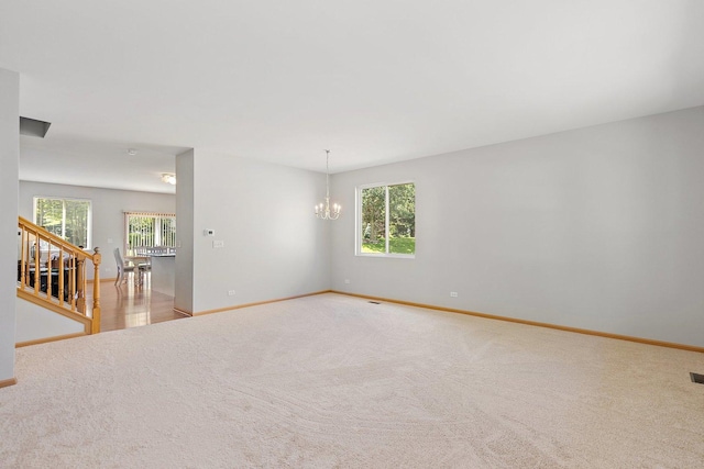 691 Glen Cove Ln, Pingree Grove, IL 60140 - empty room featuring a chandelier, carpet floors, and stairway