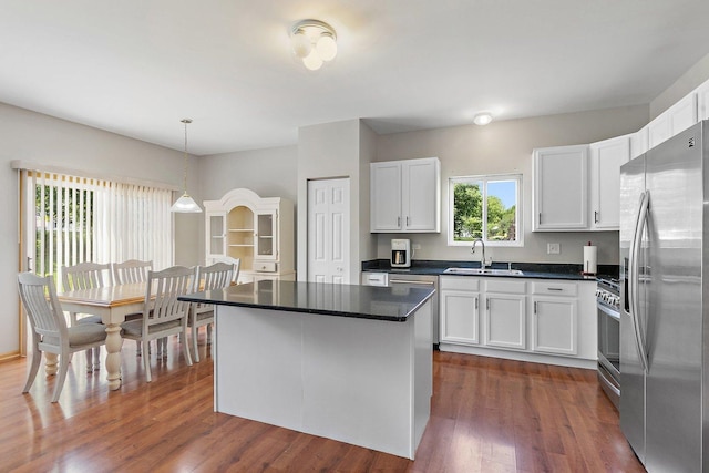691 Glen Cove Ln, Pingree Grove, IL 60140 - kitchen with stainless steel appliances, dark countertops, white cabinets, and dark wood finished floors