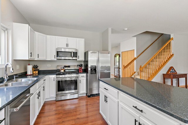 691 Glen Cove Ln, Pingree Grove, IL 60140 - kitchen with appliances with stainless steel finishes, wood finished floors, white cabinets, and dark stone countertops