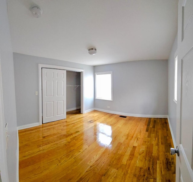 14610 Lincoln Ave, Dolton, IL 60419 - unfurnished bedroom featuring wood finished floors and a closet