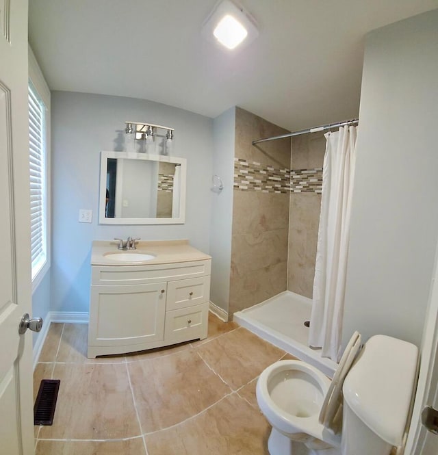 14610 Lincoln Ave, Dolton, IL 60419 - full bathroom with tile patterned flooring, tiled shower, vanity, and healthy amount of natural light