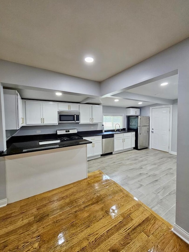14610 Lincoln Ave, Dolton, IL 60419 - kitchen featuring stainless steel appliances, white cabinetry, dark countertops, recessed lighting, and light wood-style flooring