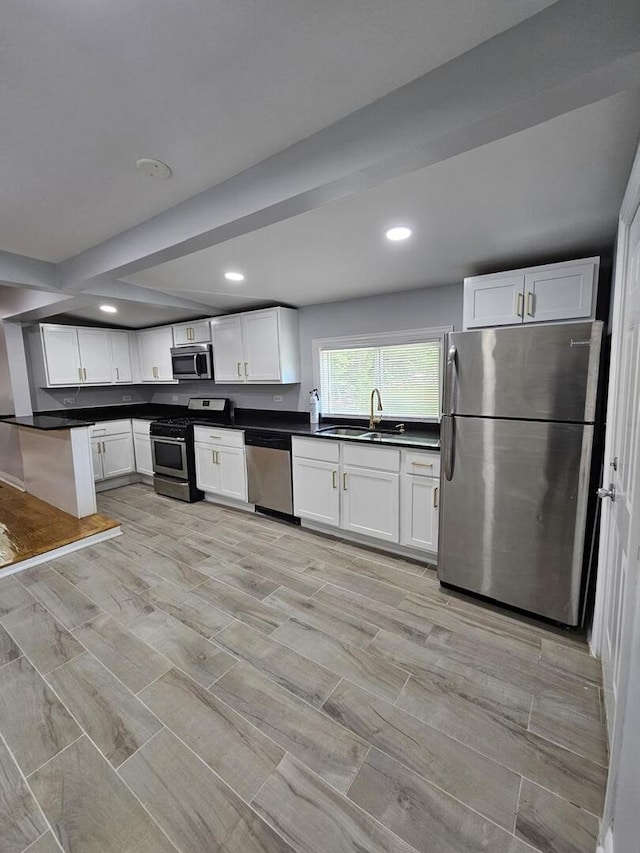 14610 Lincoln Ave, Dolton, IL 60419 - kitchen with appliances with stainless steel finishes, dark countertops, white cabinets, recessed lighting, and wood tiled floors