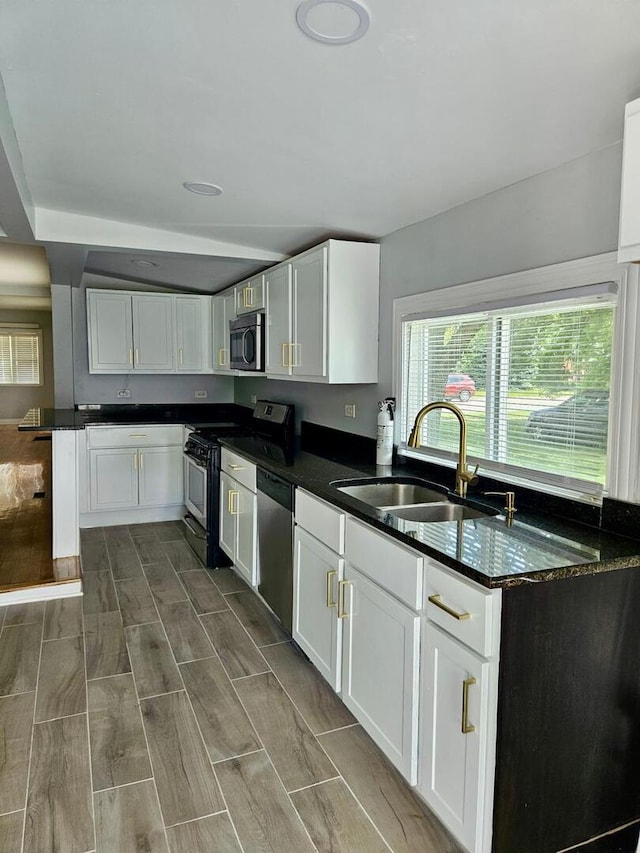 14610 Lincoln Ave, Dolton, IL 60419 - kitchen featuring stainless steel appliances, white cabinets, dark stone counters, and wood tiled floors