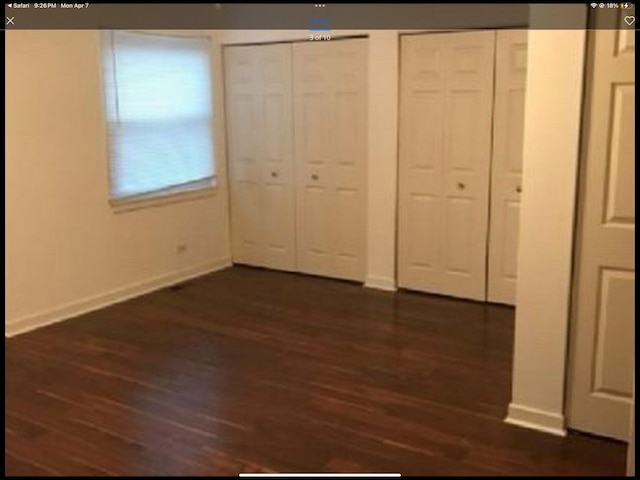 6419 S Kenwood Ave, Chicago, IL 60637 - unfurnished bedroom with two closets and dark wood-style floors