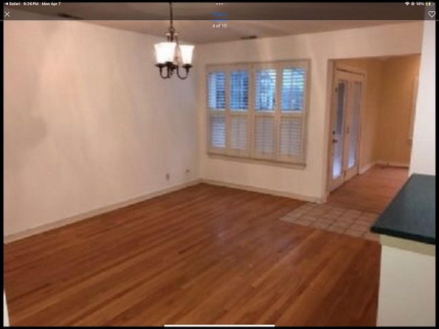 6419 S Kenwood Ave, Chicago, IL 60637 - unfurnished dining area with wood finished floors and a chandelier