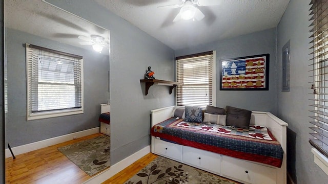 1713 Glenn Park Dr, Champaign, IL 61821 - bedroom with wood finished floors, a textured ceiling, and a ceiling fan